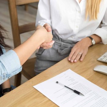 two-women-partners-handshaking-after-signing-business-contract-meeting two-women-partners-handshaking-after-signing-business-contract-meeting